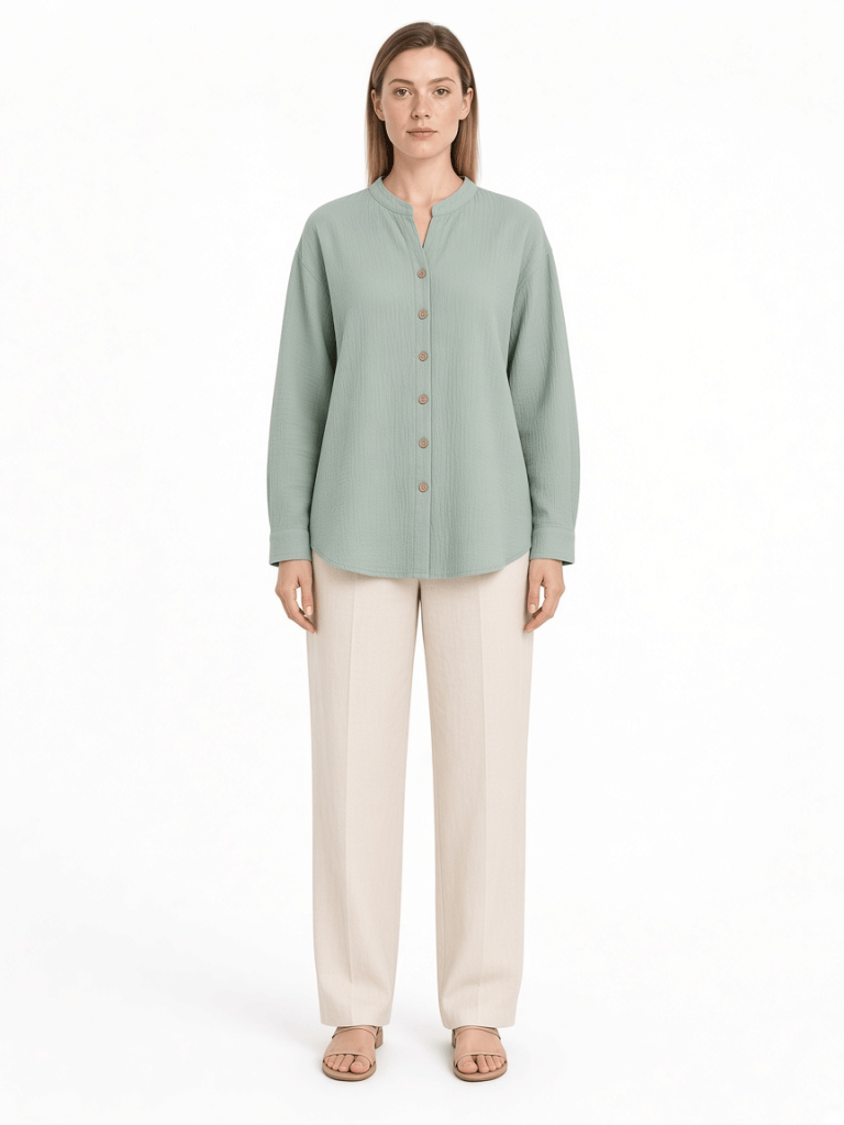Sage green band-collar woven shirt with button front, long sleeves and curved hem on a model