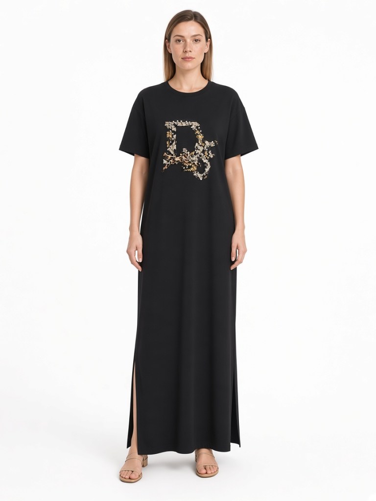 FM-LK-051 Black crew-neck T-shirt maxi dress with short sleeves, a gold-toned decorative front motif and side slits shown on a model